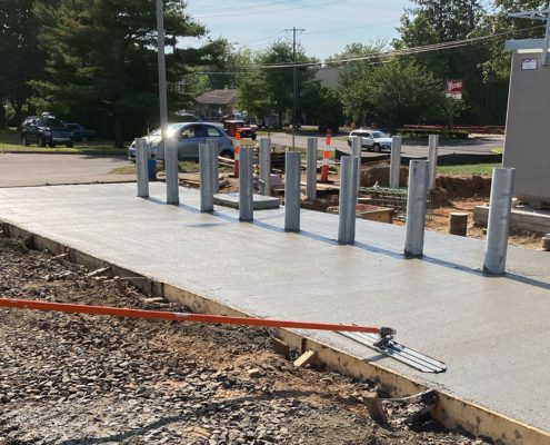 Freshly poured concrete with metal posts