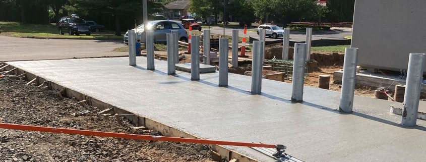 Freshly poured concrete with metal posts