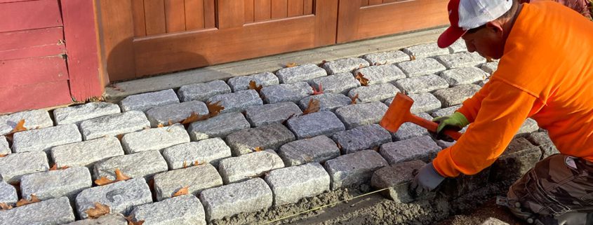 Man placing stones beside wooden door