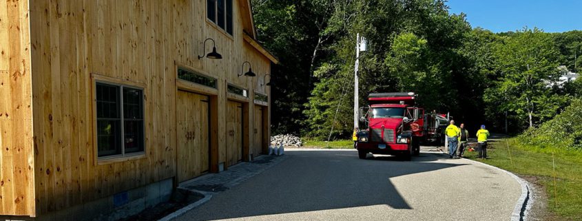 Driveway work beside timber structure