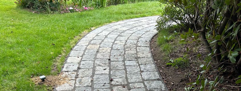 Curved pathway leading to a white chapel