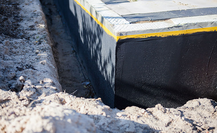 Concrete is being poured into the ground, underscoring drainage solutions and foundation waterproofing in Stonington, CT.