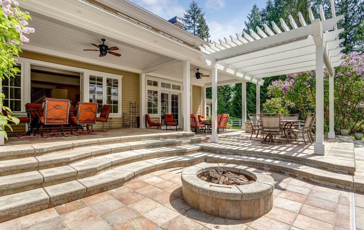 A cozy patio featuring a fire pit and seating area, designed by a Mason Contractor in Branford, CT.