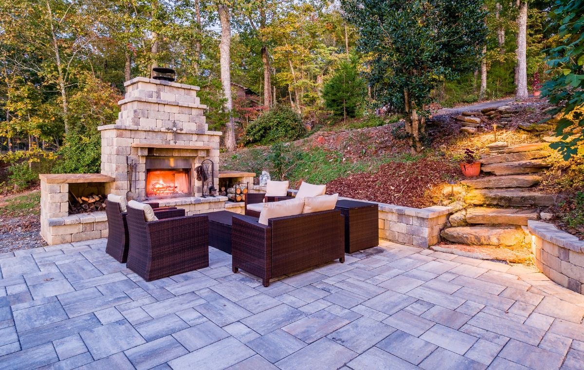 Elegant patio space with a fire pit and seating, highlighting the work of a Mason Contractor in Essex, CT.