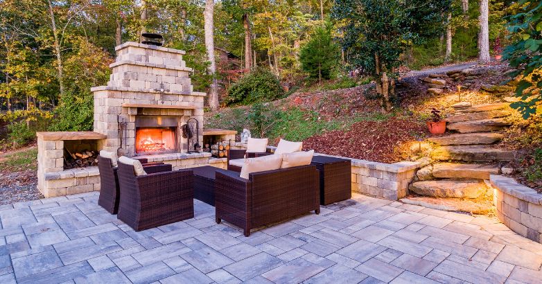 A cozy patio featuring a fireplace surrounded by comfortable seating for relaxation and social gatherings.