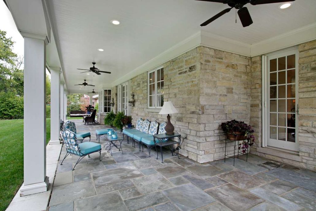 A patio featuring bluestone pavers and a stone walkway, showcasing a stylish outdoor living space.