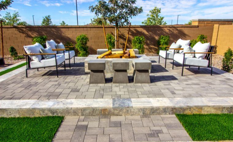 Outdoor patio with a fire pit and seating, showcasing masonry work by a construction company in Stonington, CT.
