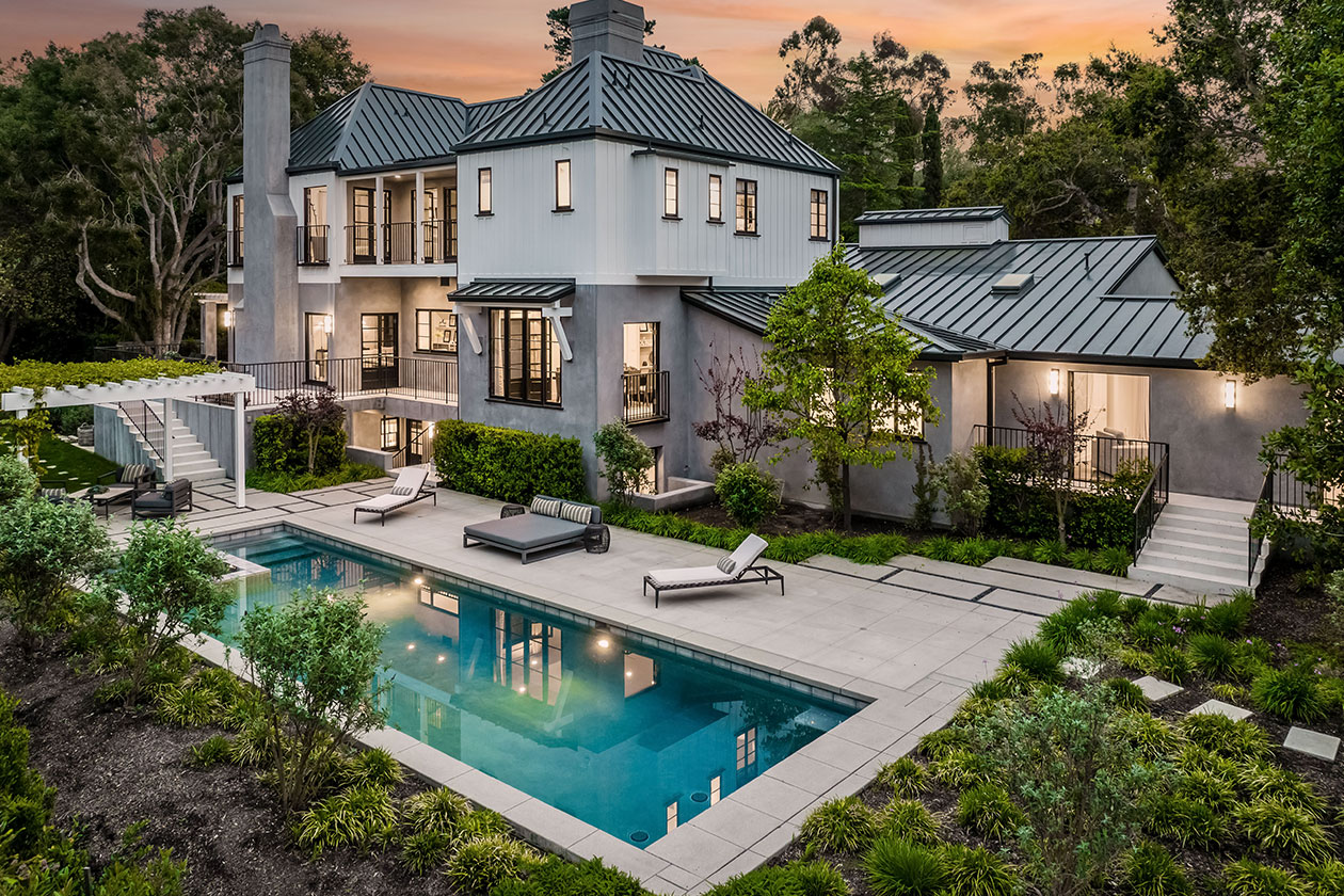 Elegant home with a pool and patio, highlighting luxury outdoor spaces in Essex, CT.