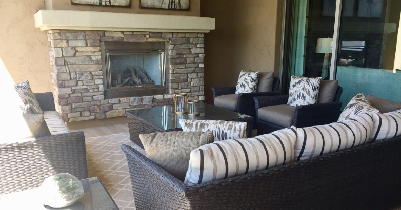 Cozy patio featuring natural stone masonry fireplace and stylish outdoor furniture for relaxation and gatherings.