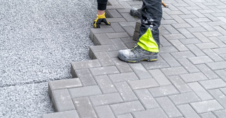 Installing gray concrete pavers on gravel base—durable solution for varying climate conditions and drainage