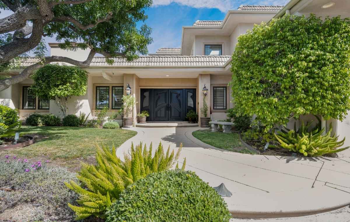A residential property with a large driveway and attractive landscaping, highlighting the expertise of a front walkway contractor in Old Saybrook, CT.