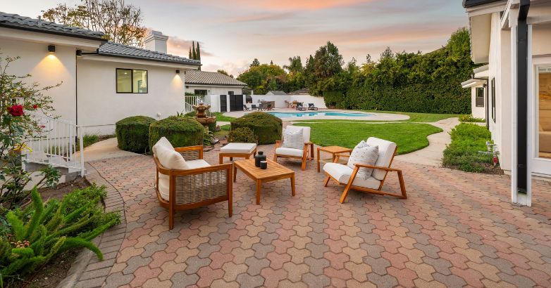 Brick paver patio seating area in backyard showing low-maintenance surface and long-term repair flexibility.