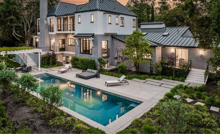 A large residence with a pool and patio area, emphasizing bluestone options for the pool deck in Darien, CT.