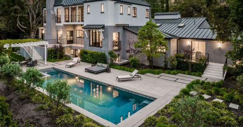 Luxury backyard patio with pool and stone hardscape for high-end outdoor living design