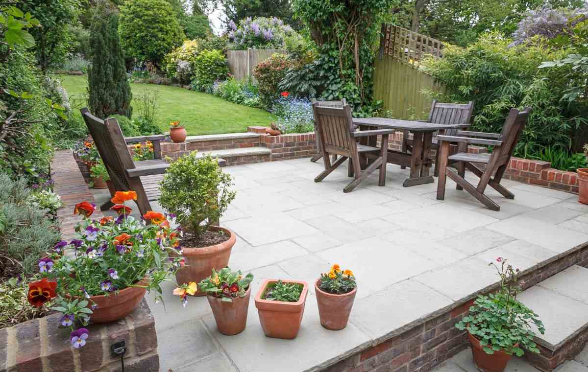 Stone patio with garden seating and planters by installers in Guilford CT