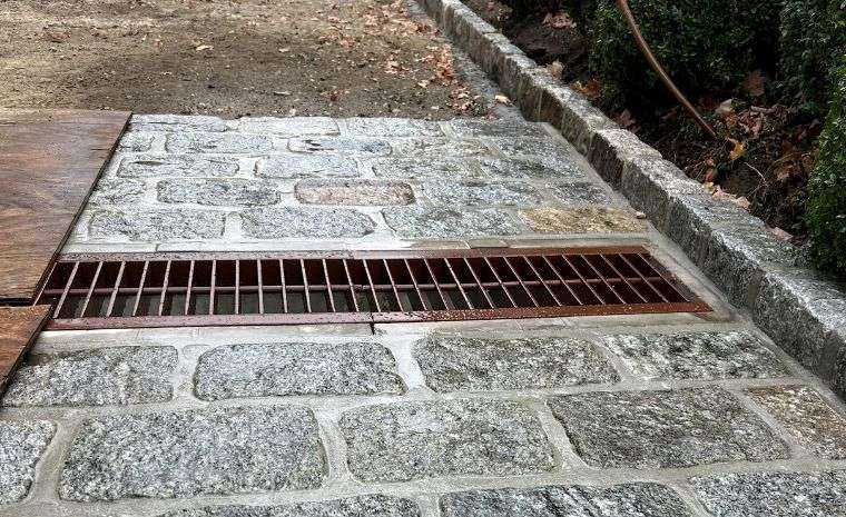 Stone patio installation in Westport CT with proper drainage system and channel grate design
