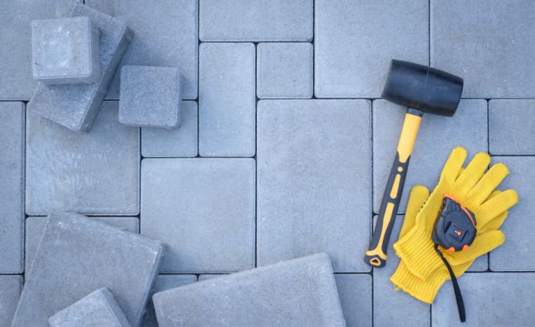 Concrete pavers with installation tools and patio materials in Chester CT