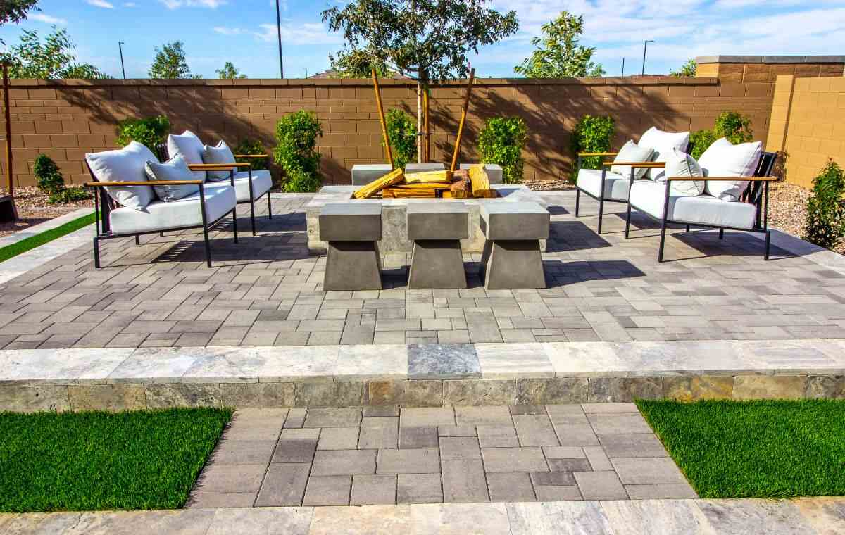 Modern paver patio with outdoor fire feature and lounge seating in Madison CT