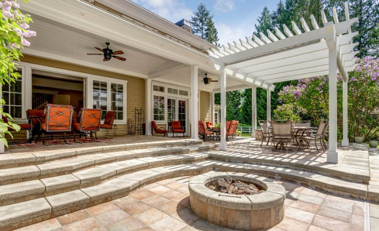 Paver patio with clean stone edging and custom fire pit design in Madison CT