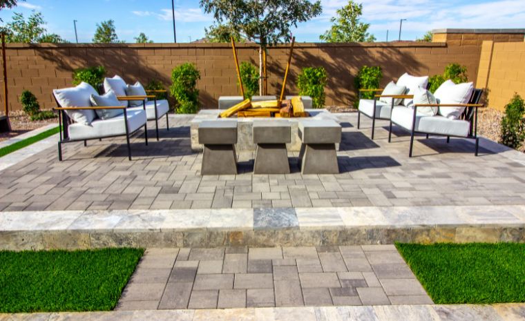 Paver patio with modern outdoor seating area and custom stone hardscape design in Old Saybrook CT
