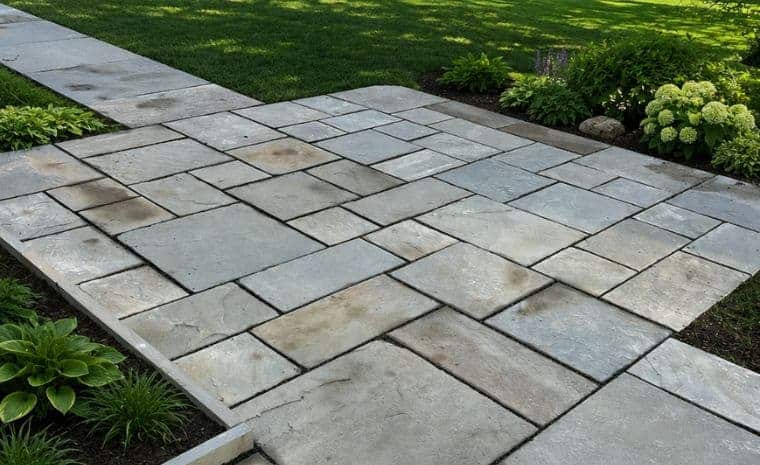 Custom bluestone patio and walkway with geometric stone pattern in Essex, CT