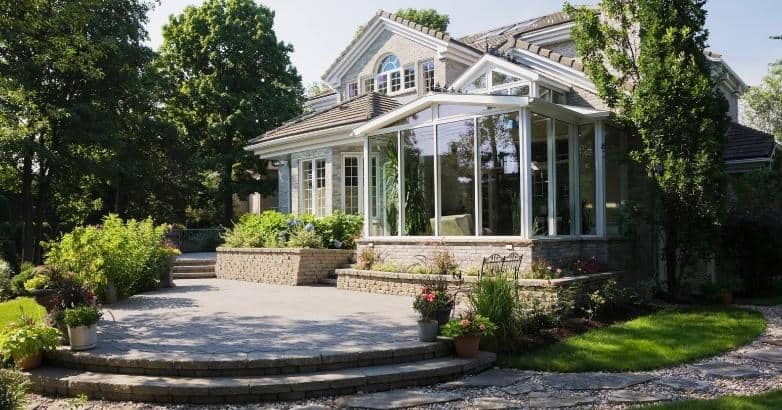 Stone patio with retaining walls and landscaped backyard in Connecticut