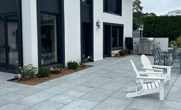 Granite stone patio with outdoor dining, lounge seating built by granite stone patio contractor in Essex CT