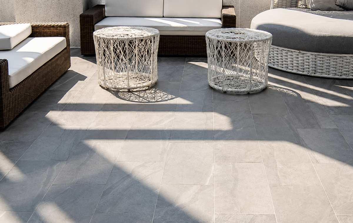 Granite stone patio with wicker lounge furniture at an Old Lyme CT home
