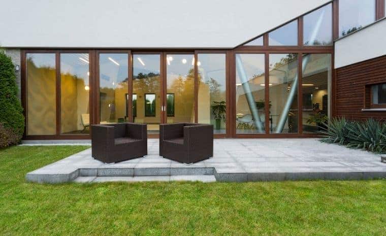 Custom granite stone patio with lounge seating at a modern Old Lyme CT home