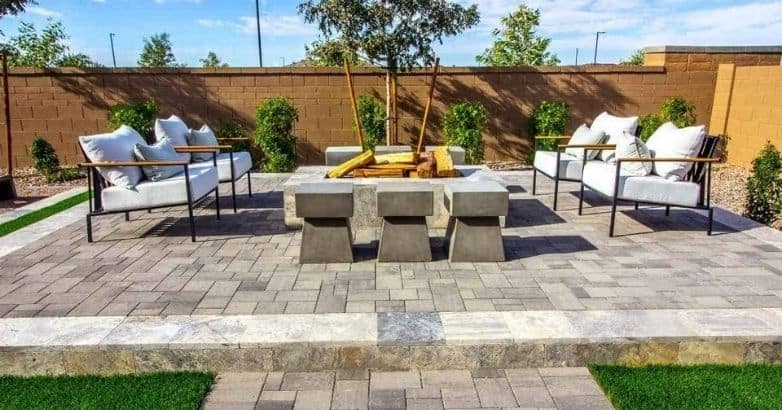 Bluestone VS Granite for Patios: Cost-effective paver patio design with outdoor seating and fire pit area