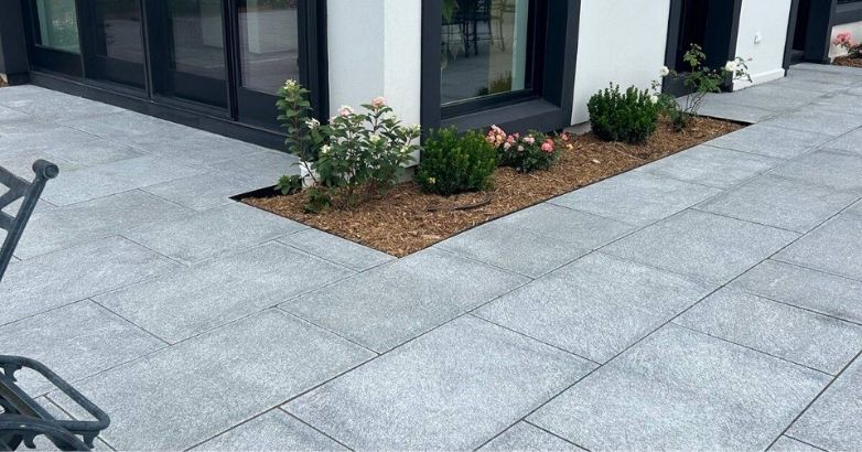 Granite patio installation with custom stone patterns and modern outdoor design